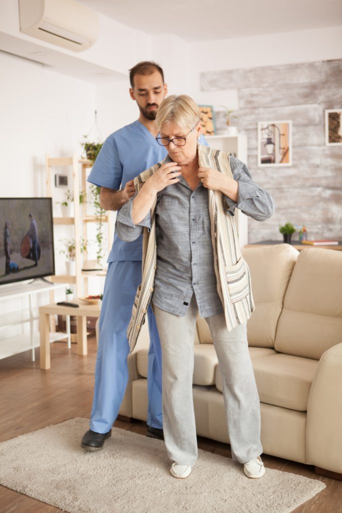 Male doctor in nursing home wearing blue uniform